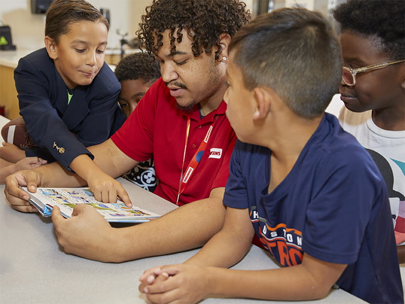 teacher helping students with homework