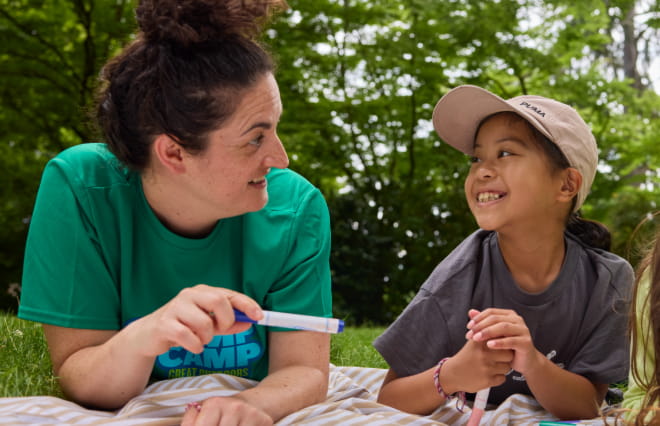 girl talking with a camp counselor 